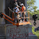 On Thursday, workers prepared the top of a 38-foot-tall granite monument to the Confederacy in St. Louis for removal with a crane. The bulk of the memorial might remain in place for weeks. (David Carson/St. Louis Post-Dispatch)
